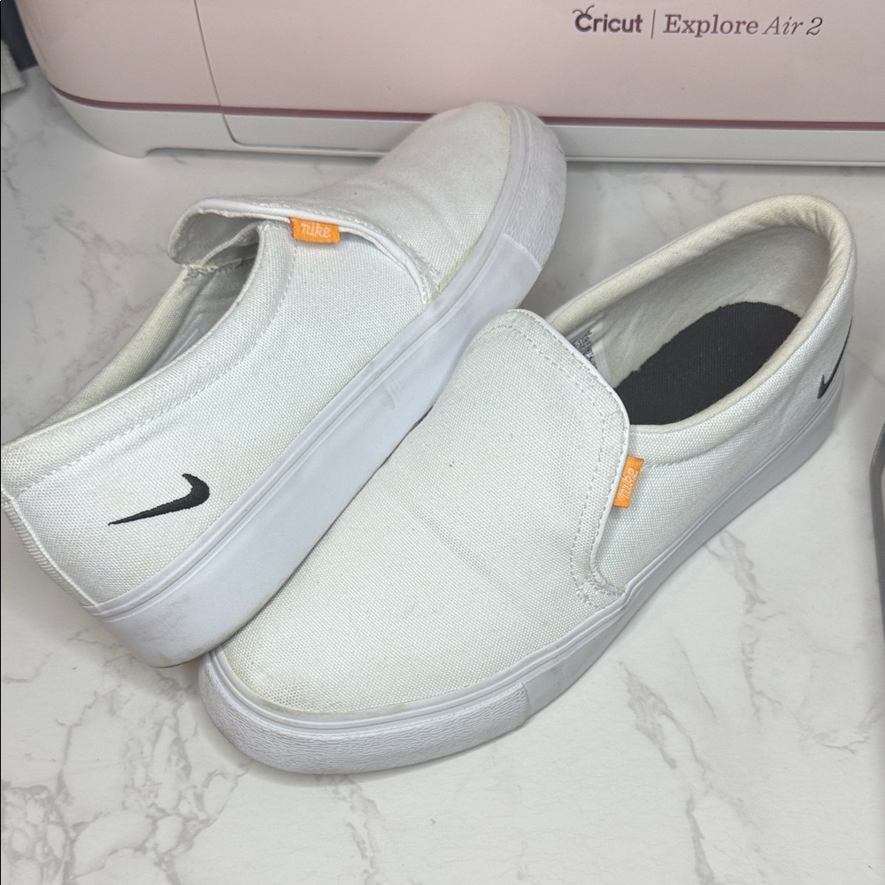 Nike White Canvas Slip-Ons with Orange Accent
